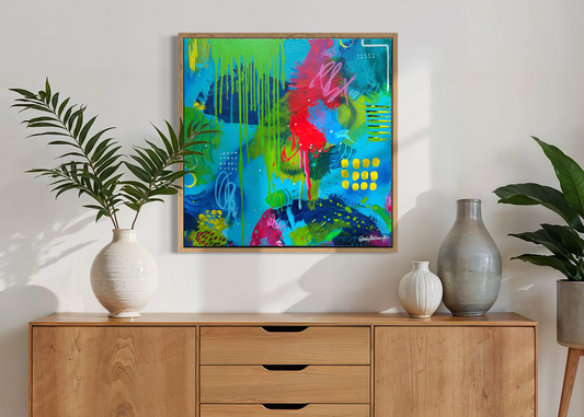 Wooden sideboard with decorative items and a colorful abstract painting in a living room setting.