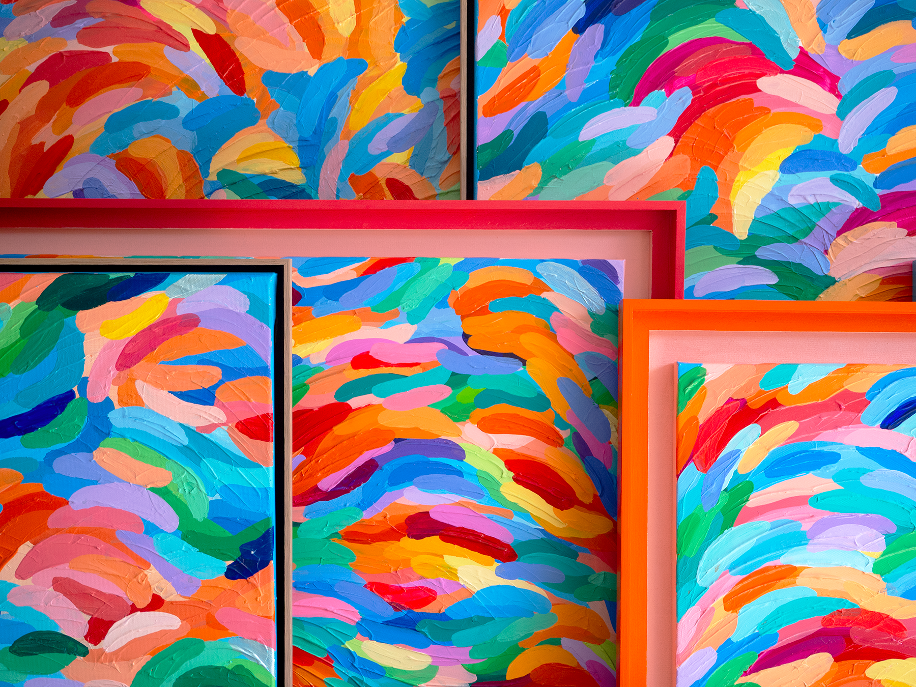 Three framed abstract paintings with vibrant, colorful brushstrokes in shades of blue, orange, pink, yellow, green, and red, arranged together against a neutral background.