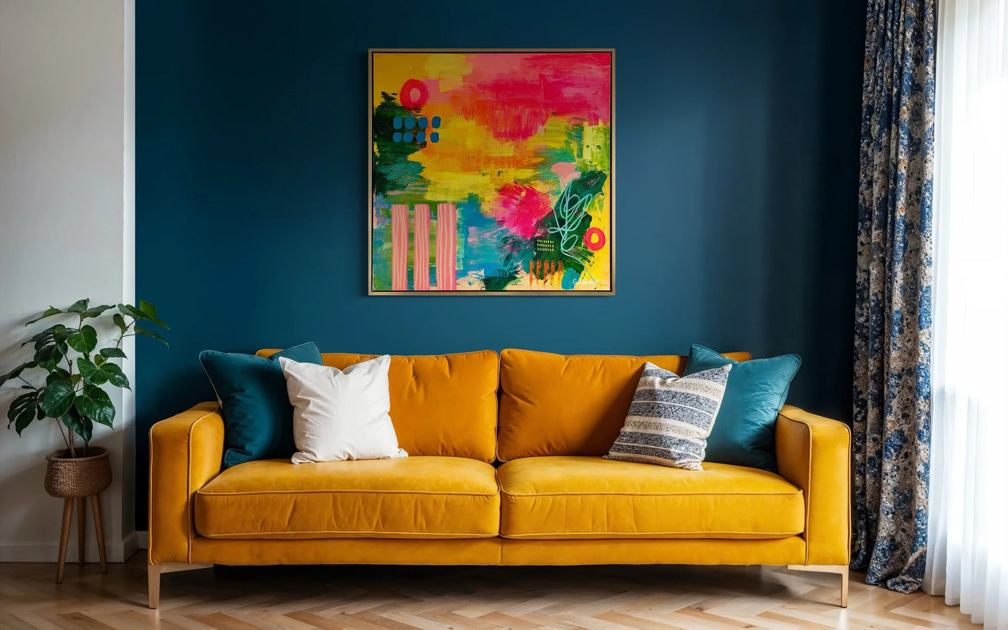 Yellow sofa with colorful pillows against a blue wall with a vibrant abstract painting.